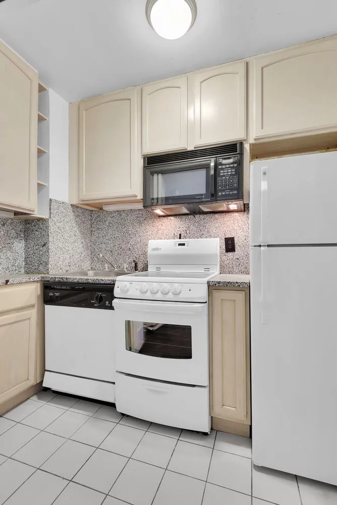 a kitchen with a stove top oven and sink