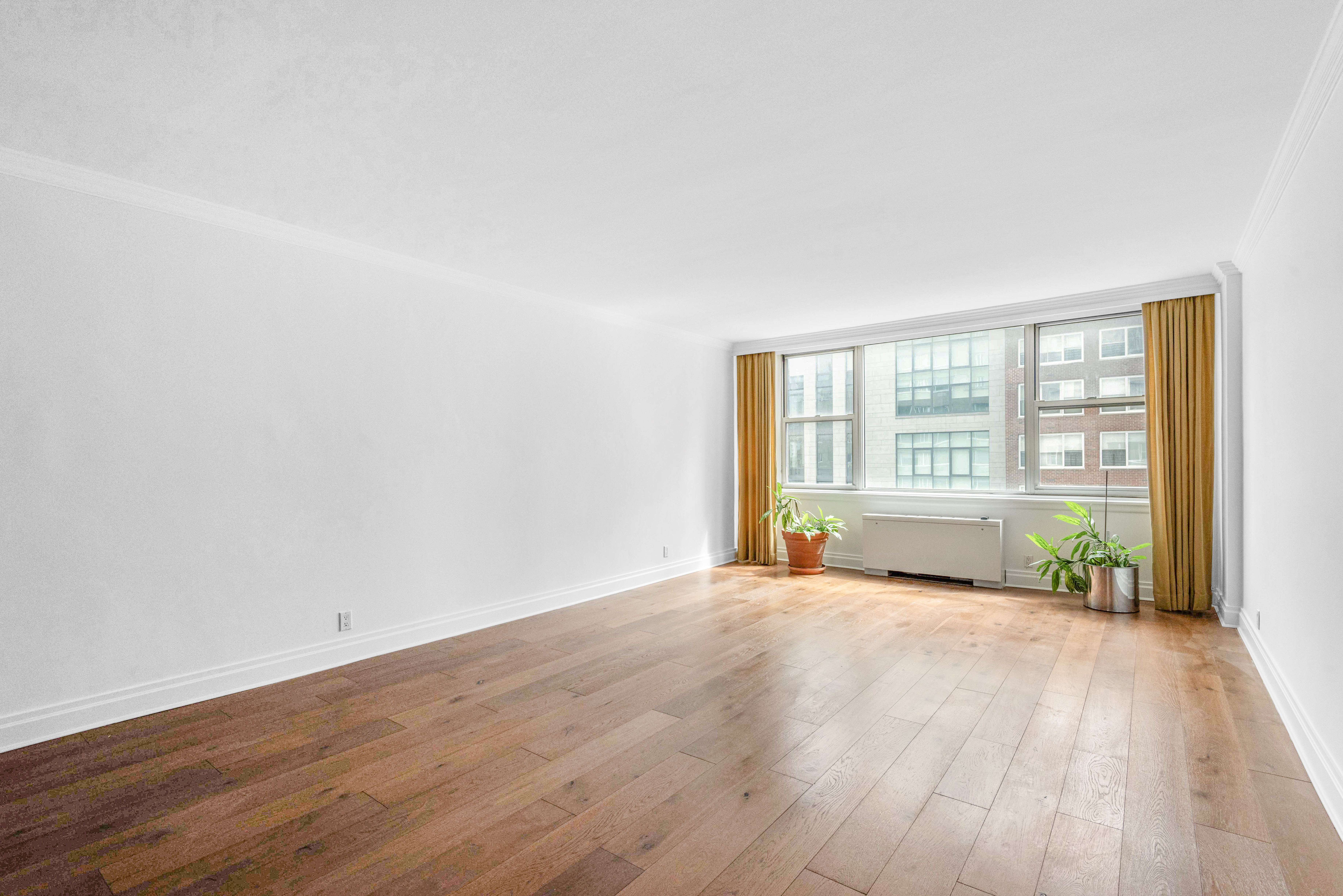 175 East 62nd Street, Unit 12A Manhattan, NY 10065 - Photo 18 of 24 a view of an empty room with wooden floor and a window