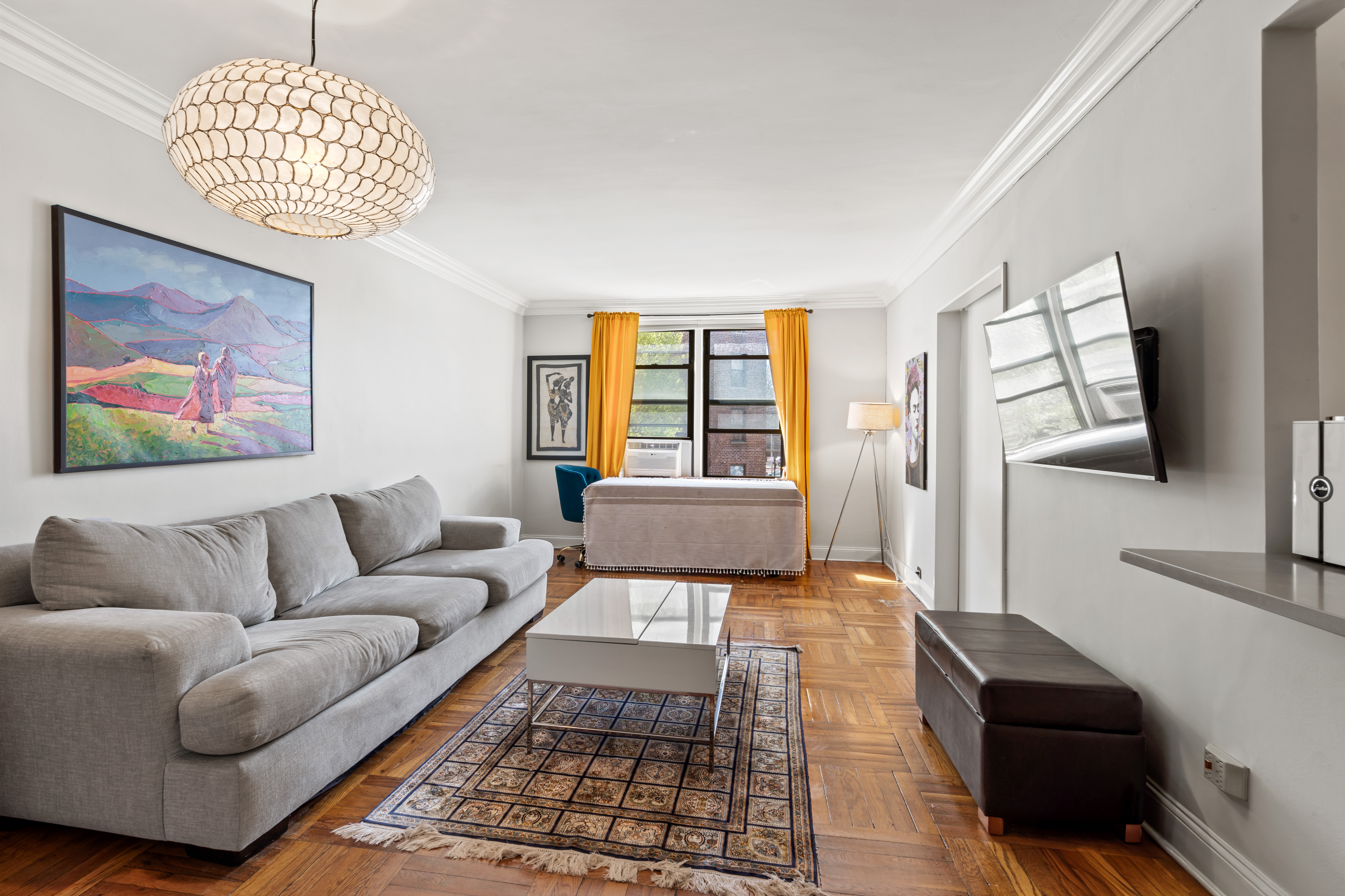 a living room with furniture and a flat screen tv