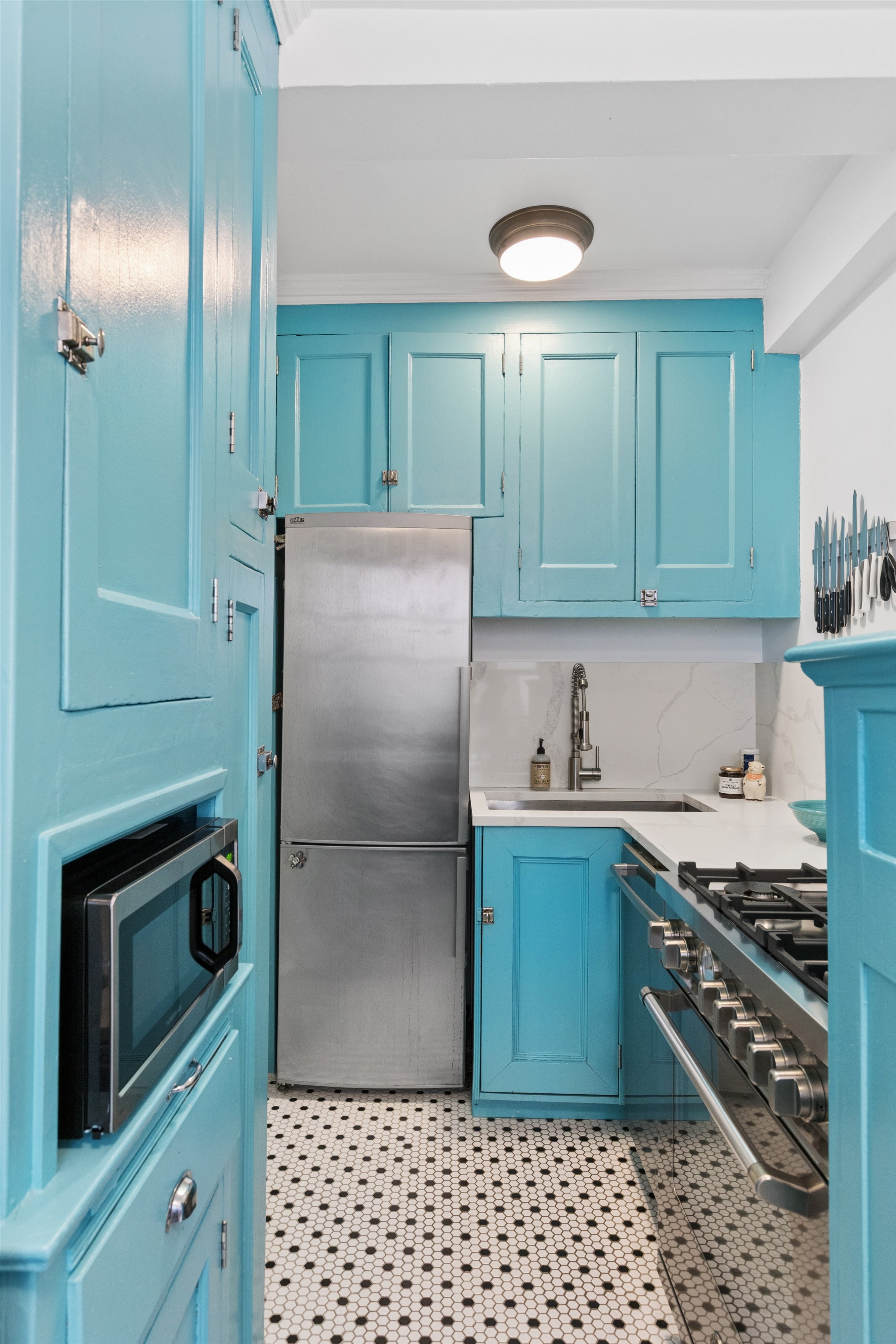 41 West 72nd Street, Unit 15E Manhattan, NY 10023 - Photo 6 of 12 a kitchen with granite countertop a cabinets and steel stainless steel appliances