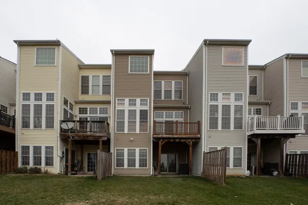 front view of a brick house with a yard
