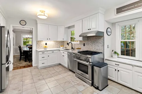 a kitchen with stainless steel appliances granite countertop a stove and a sink