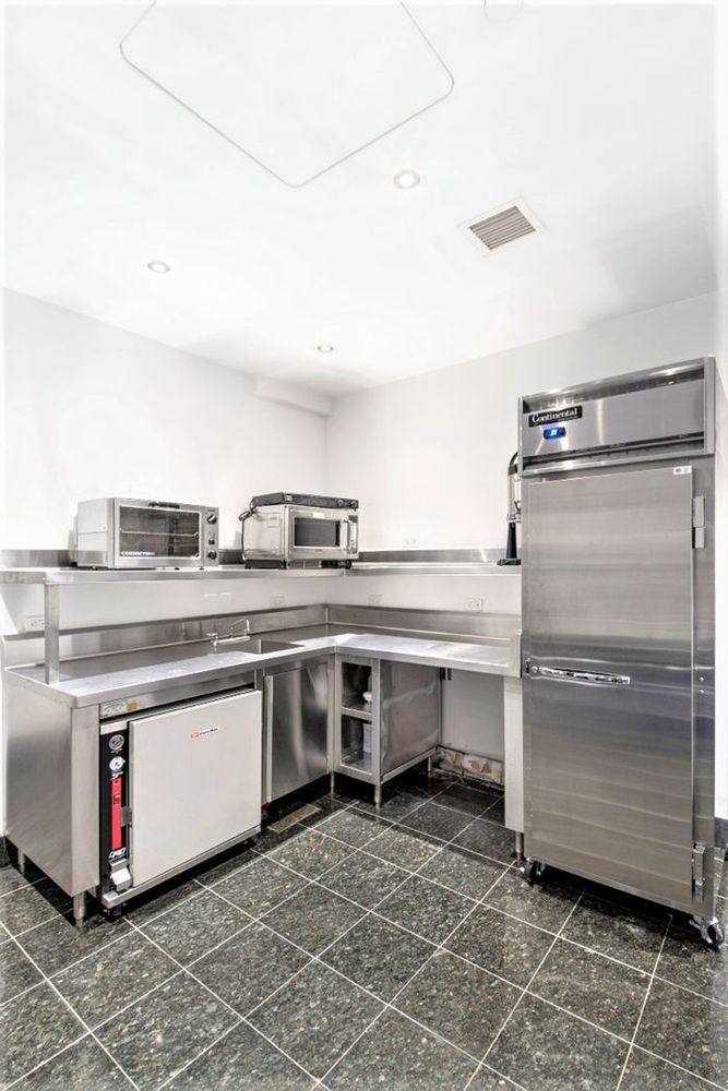 25 Columbus Circle, Unit 75A Manhattan, NY 10019 - Photo 30 of 36 a kitchen with a stove and a refrigerator