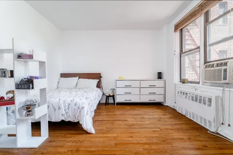 a bedroom with furniture and a window