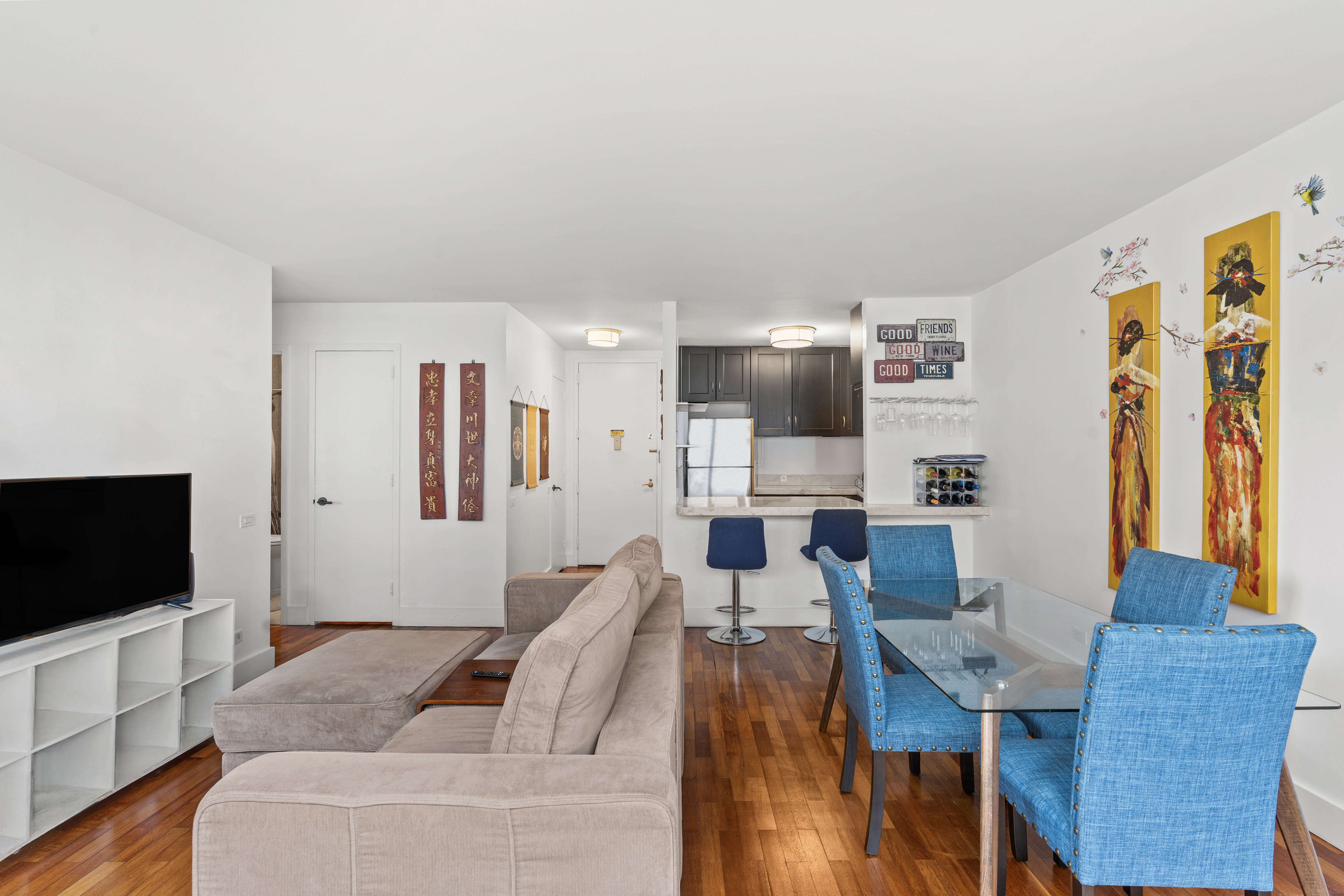 330 East 75th Street, Unit 4K Manhattan, NY 10021 - Photo 2 of 9 a living room with furniture and a flat screen tv