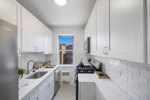 a kitchen with a sink stove and cabinets