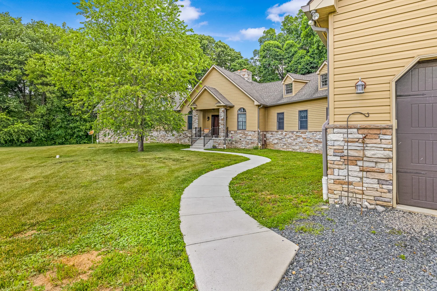 a view of a house with a yard and a garden