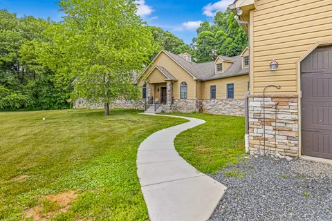 a view of a house with a yard and a garden