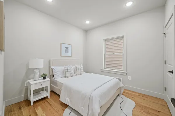 a bedroom with a bed and a table
