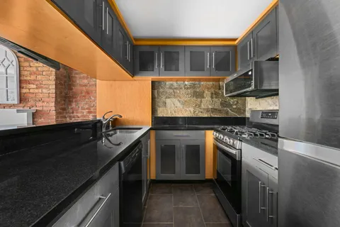 a kitchen with a sink and a stove