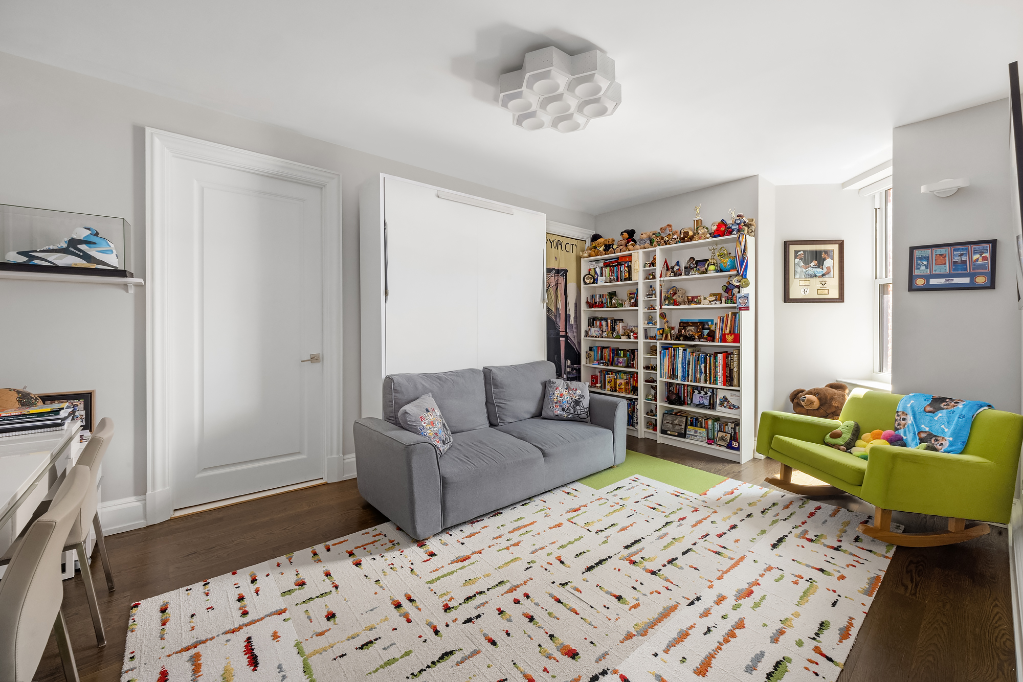 344 West 72nd Street, Unit 1007 Manhattan, NY 10023 - Photo 11 of 23 a bedroom with furniture and a book shelf