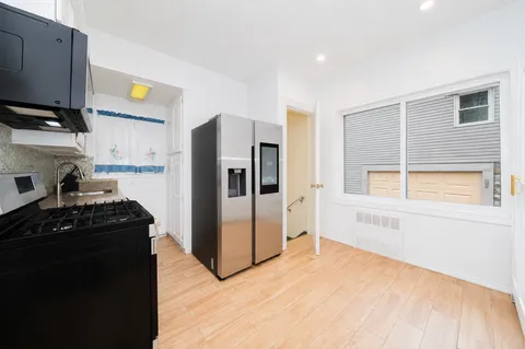 a kitchen with a refrigerator and a stove top oven