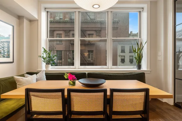 a dining room with table and chairs