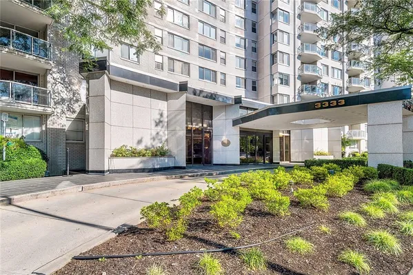 front view of a building with a tree