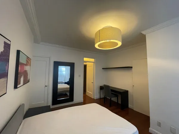 a bedroom with a bed chair and a fireplace