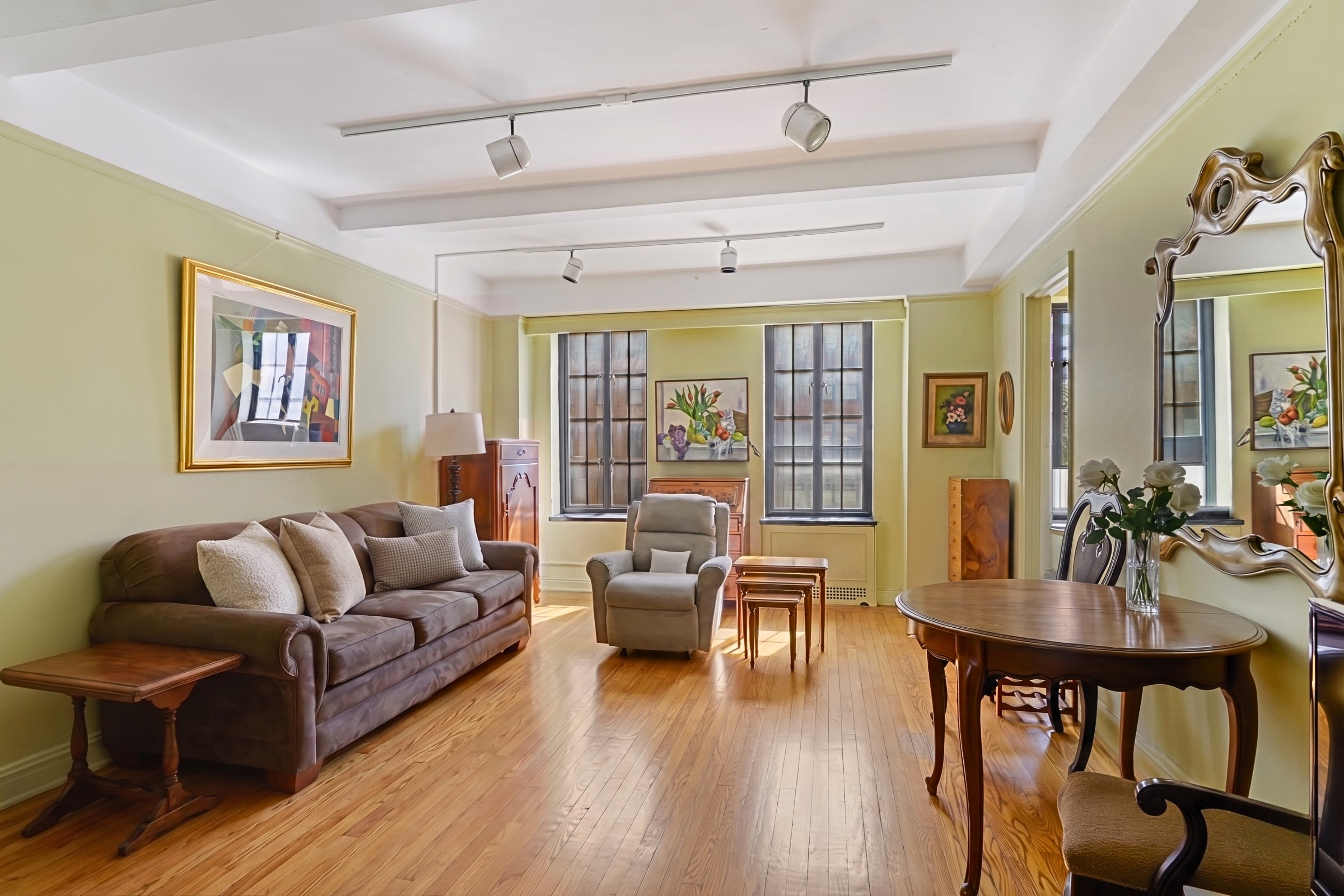 201 West 16th Street, Unit 3C Manhattan, NY 10011 - Photo 3 of 11 a living room with furniture and a wooden floor