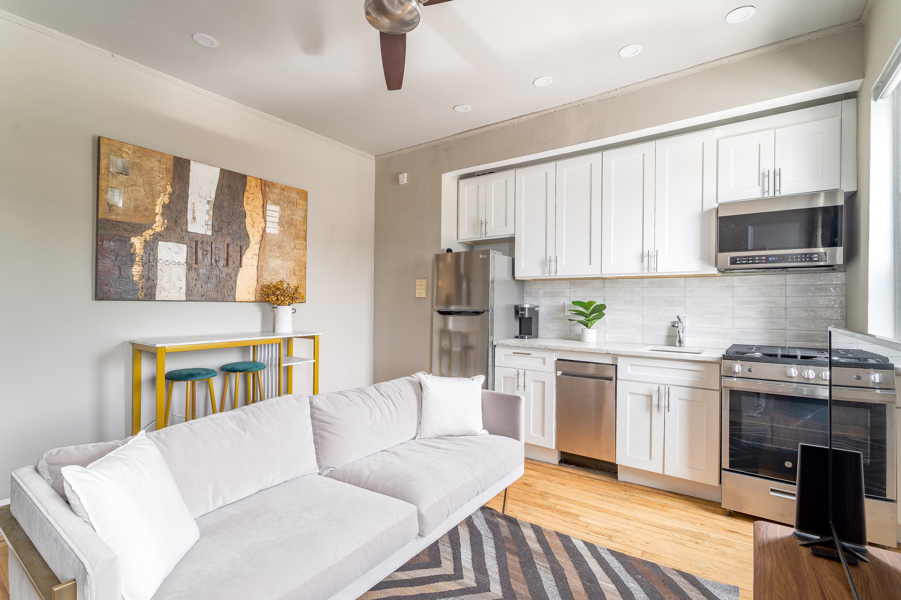 94 Hamilton Place, Unit 6E Manhattan, NY 10031 - Photo 6 of 16 a living room with stainless steel appliances granite countertop furniture a fireplace and a window