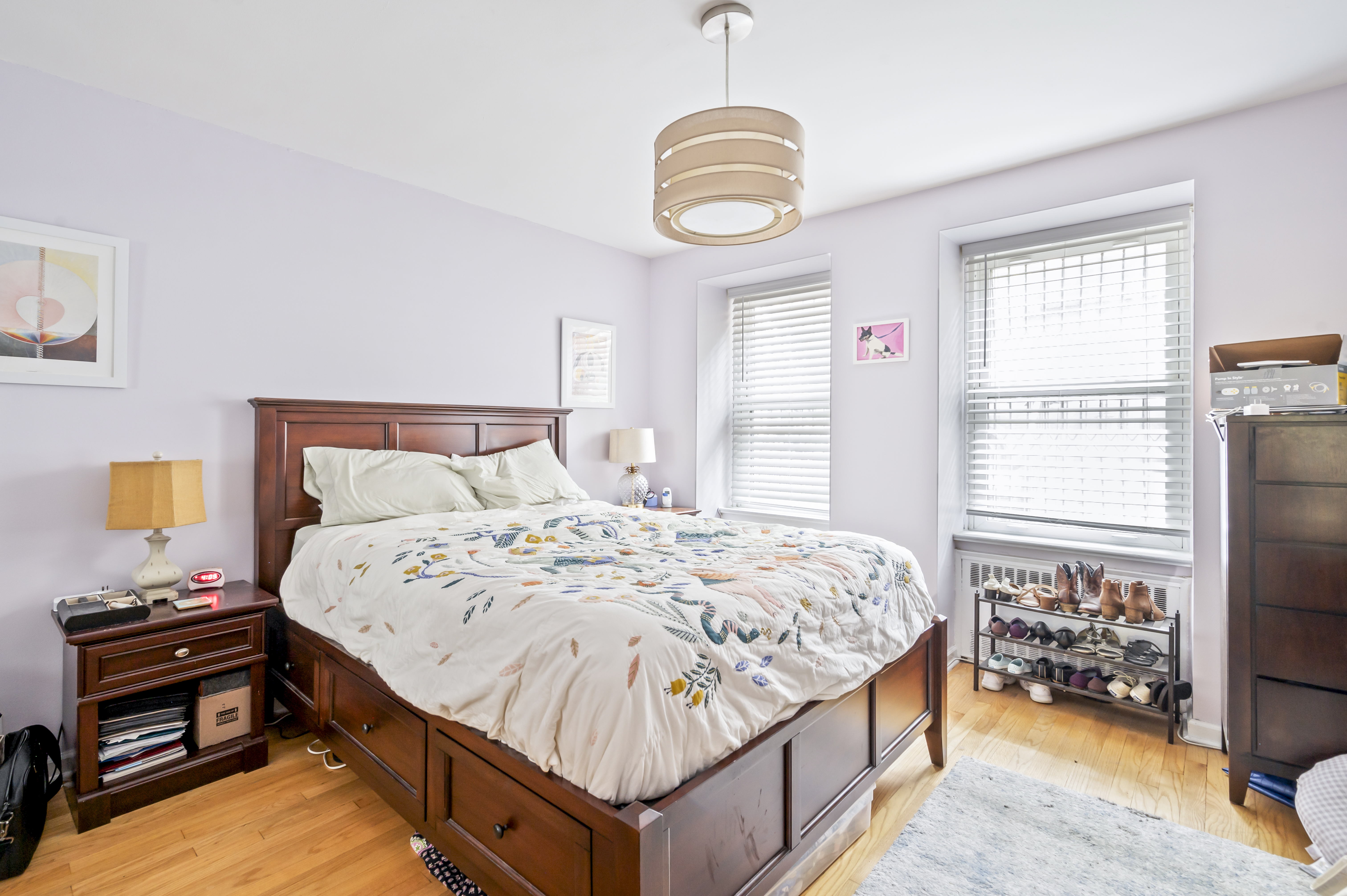53 West 94th Street Manhattan, NY 10025 - Photo 5 of 12 a bedroom with a bed and a chandelier