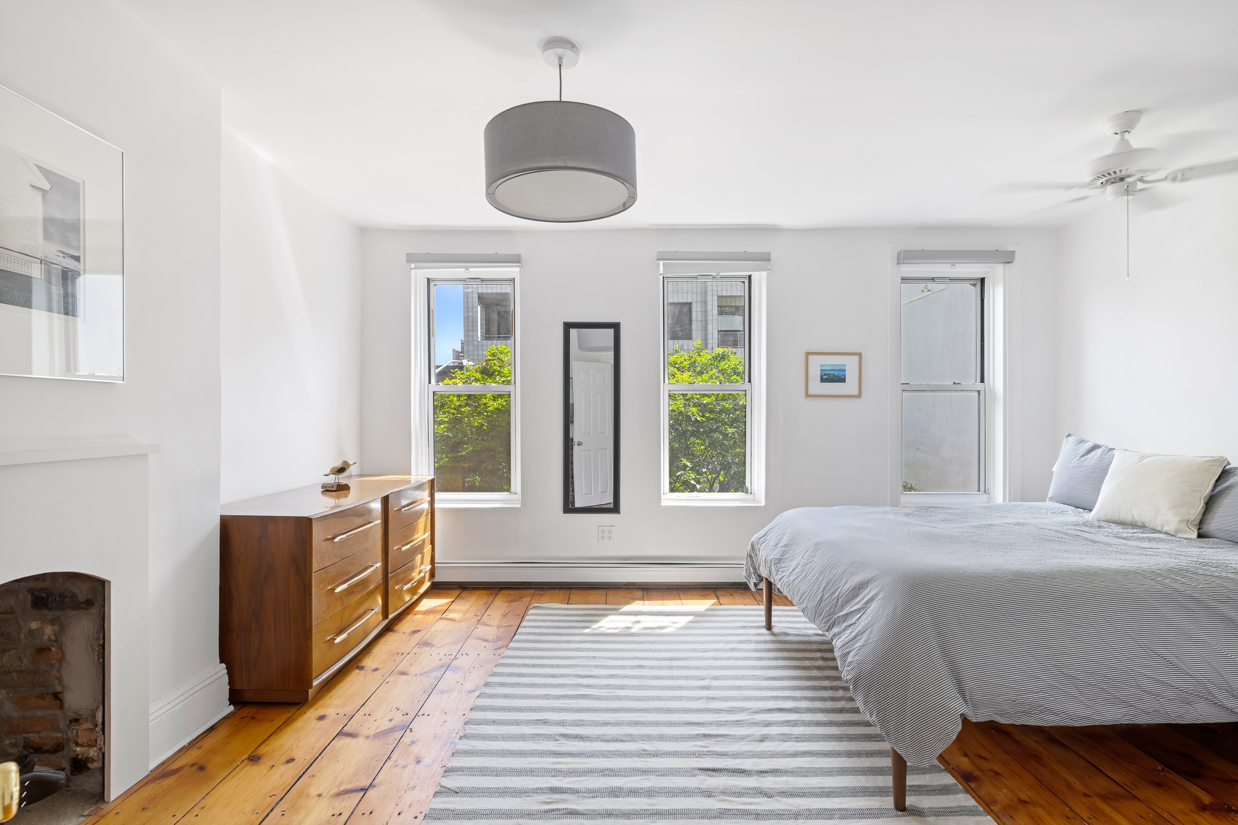 437 Warren Street Brooklyn, NY 11217 - Photo 9 of 17 a spacious bedroom with a large bed and a large window