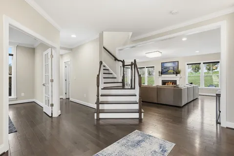a view of a livingroom with wooden floor and furniture