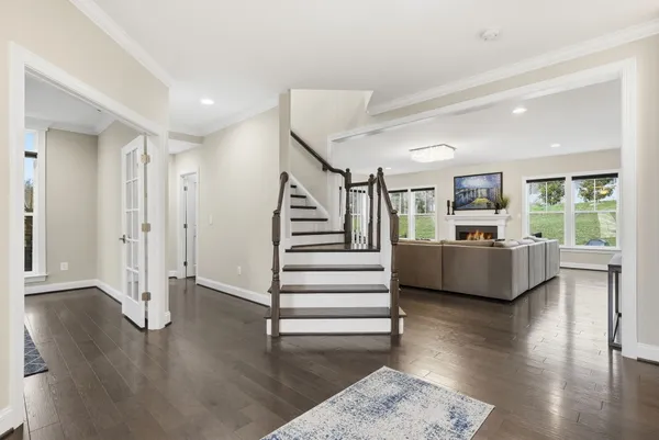 a view of a livingroom with wooden floor and furniture