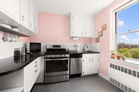 a kitchen with stainless steel appliances white cabinets and a sink