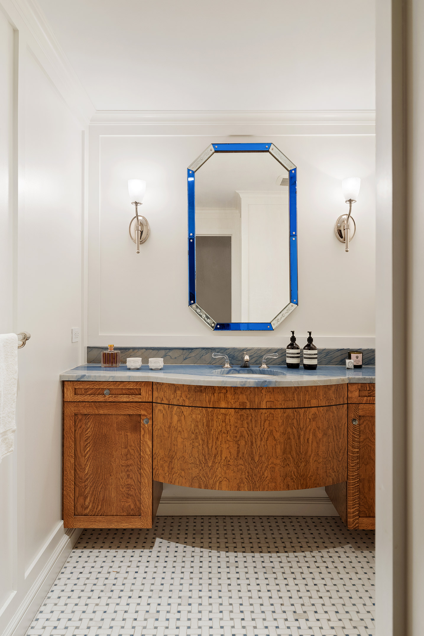 129 East 81st Street Manhattan, NY 10028 - Photo 10 of 17 a bathroom with a sink a vanity and mirror