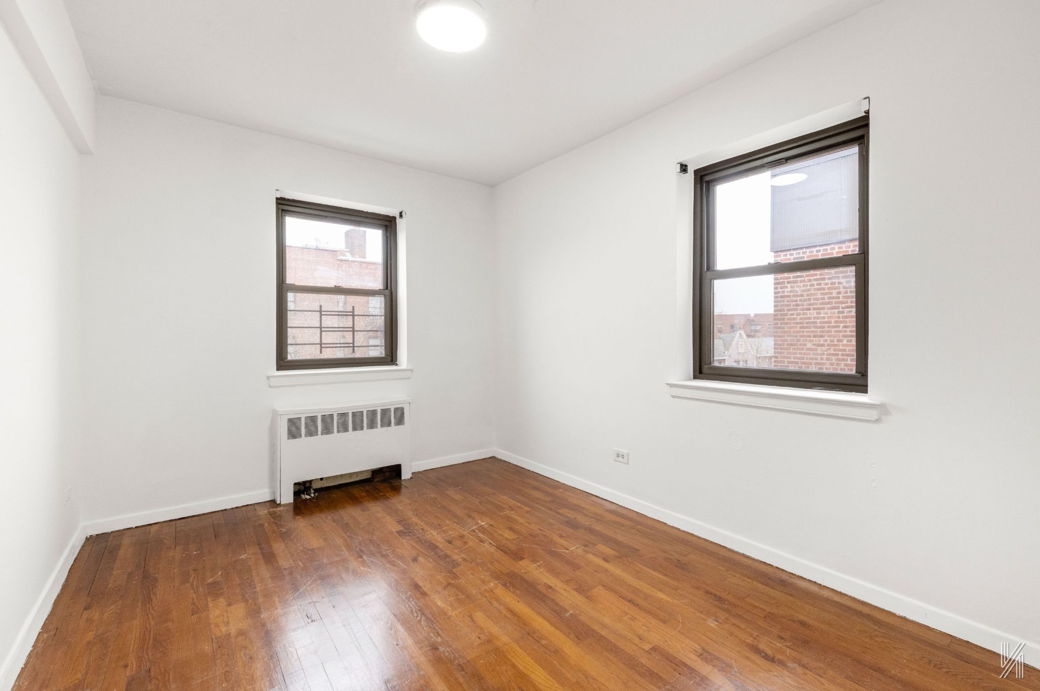 34-10 94th Street, Unit 6G Queens, NY 11372 - Photo 12 of 19 an empty room with a window