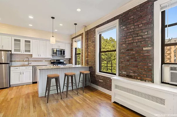 a kitchen with granite countertop white cabinets and appliances