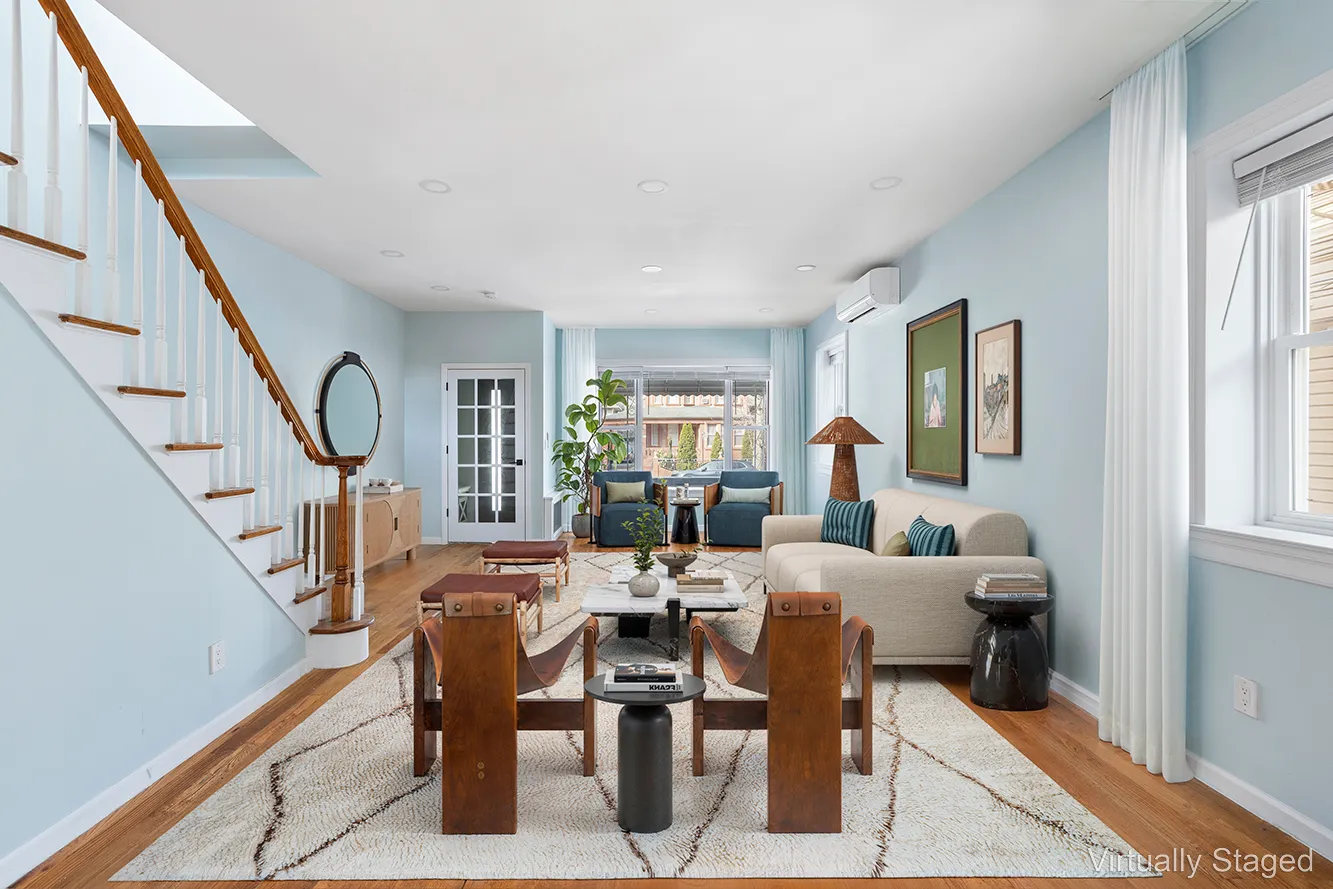 a living room with lots of furniture and a window