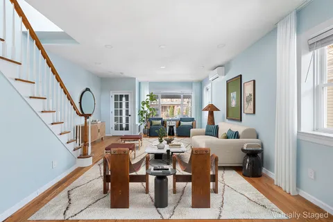 a living room with lots of furniture and a window