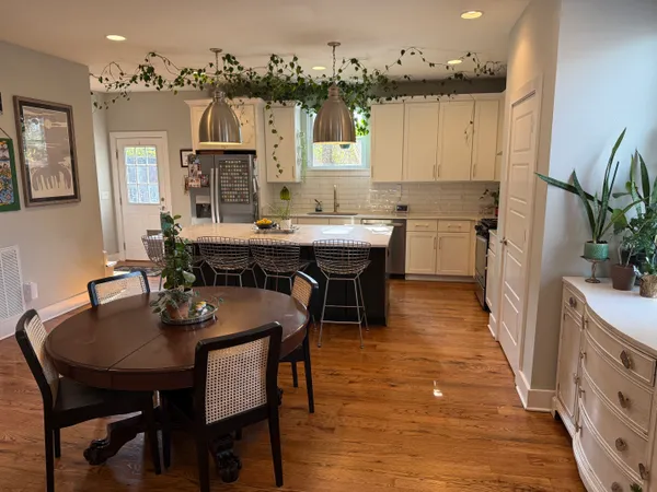 a view of a dining room with furniture and wooden floor