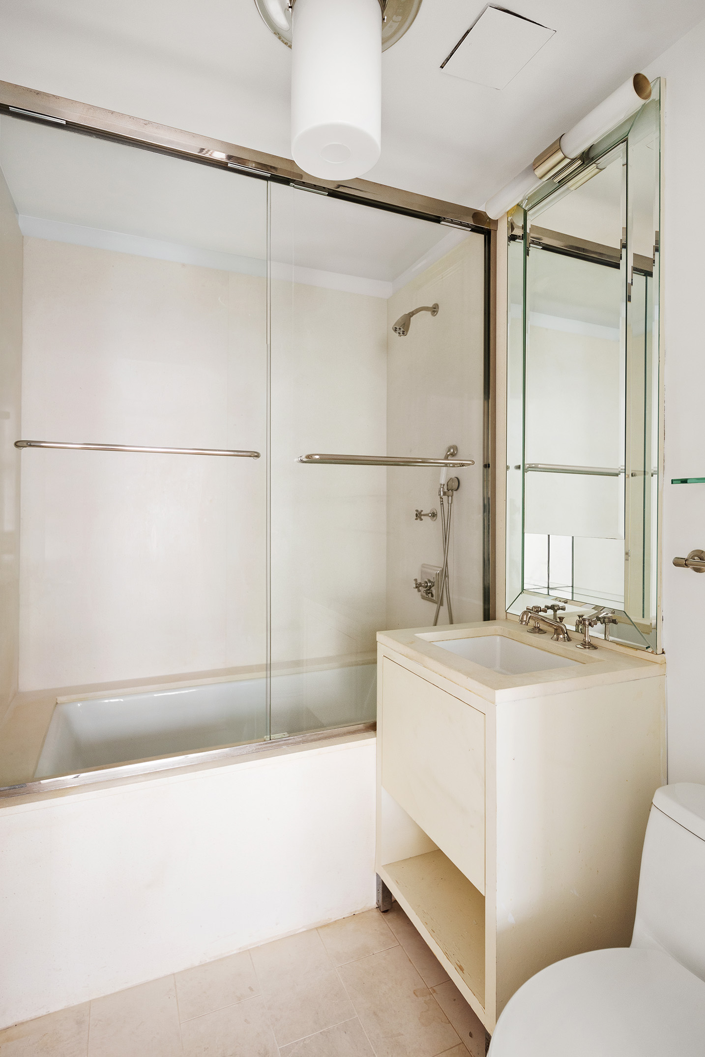 55 Wall Street, Unit 540 Manhattan, NY 10005 - Photo 7 of 10 a bathroom with a sink a toilet and shower