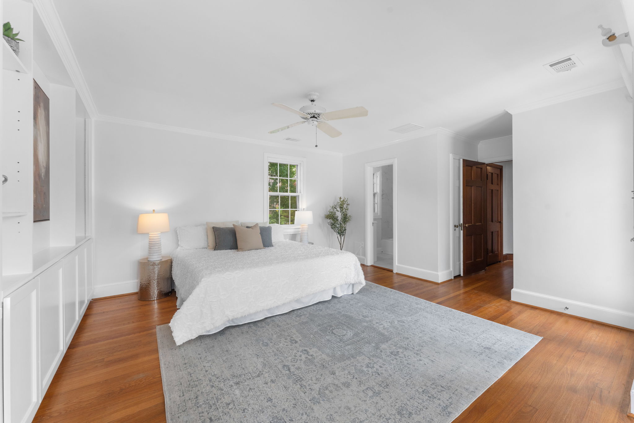 1325 Locust Road Northwest Washington, DC 20012 - Photo 24 of 56 a spacious bedroom with a bed and a lamp