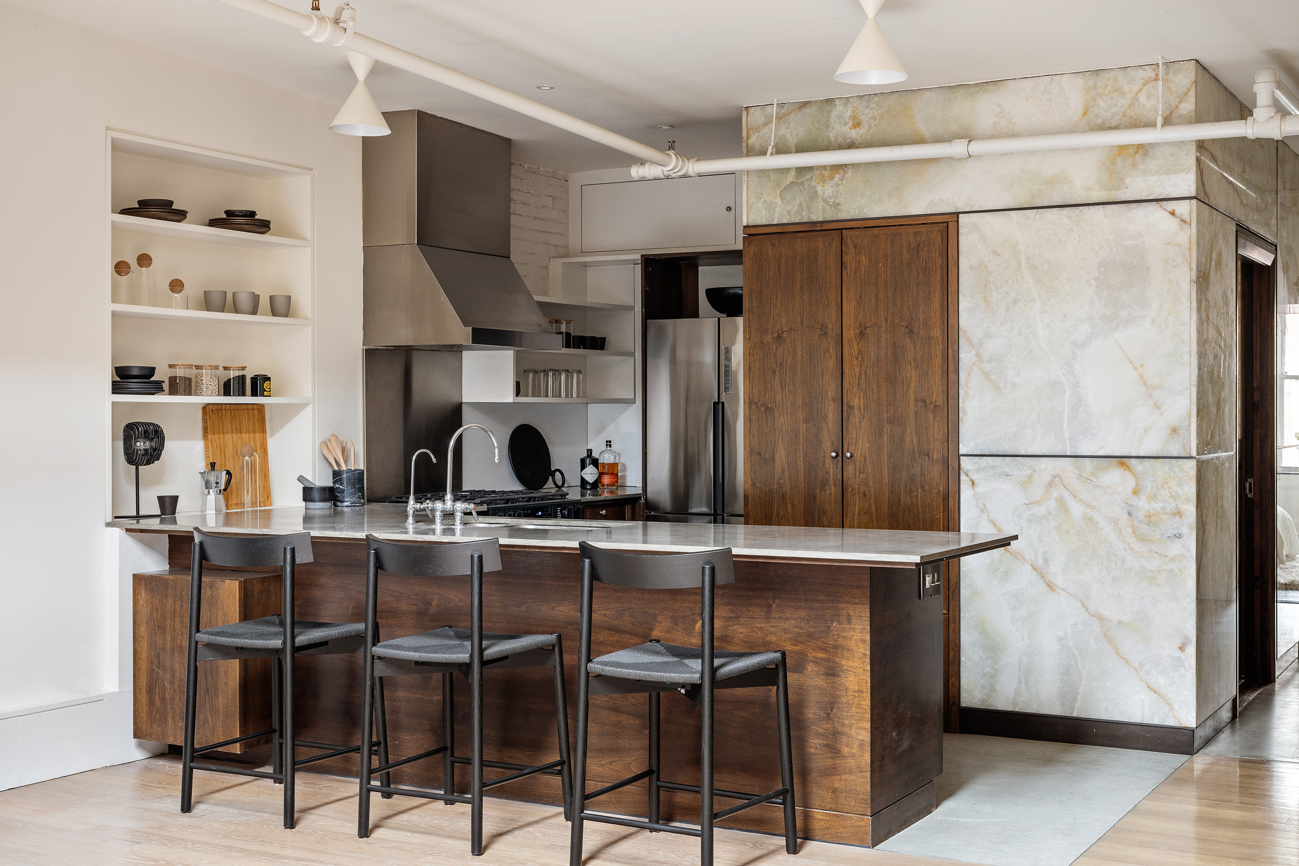 169 Mercer Street, Unit PH Manhattan, NY 10012 - Photo 6 of 15 a kitchen with stainless steel appliances a refrigerator and cabinets