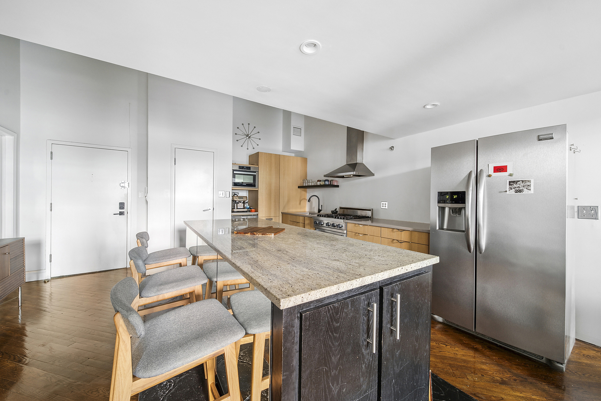121 West 20th Street, Unit 3C Manhattan, NY 10011 - Photo 4 of 10 a kitchen with stainless steel appliances granite countertop a refrigerator a stove and a refrigerator