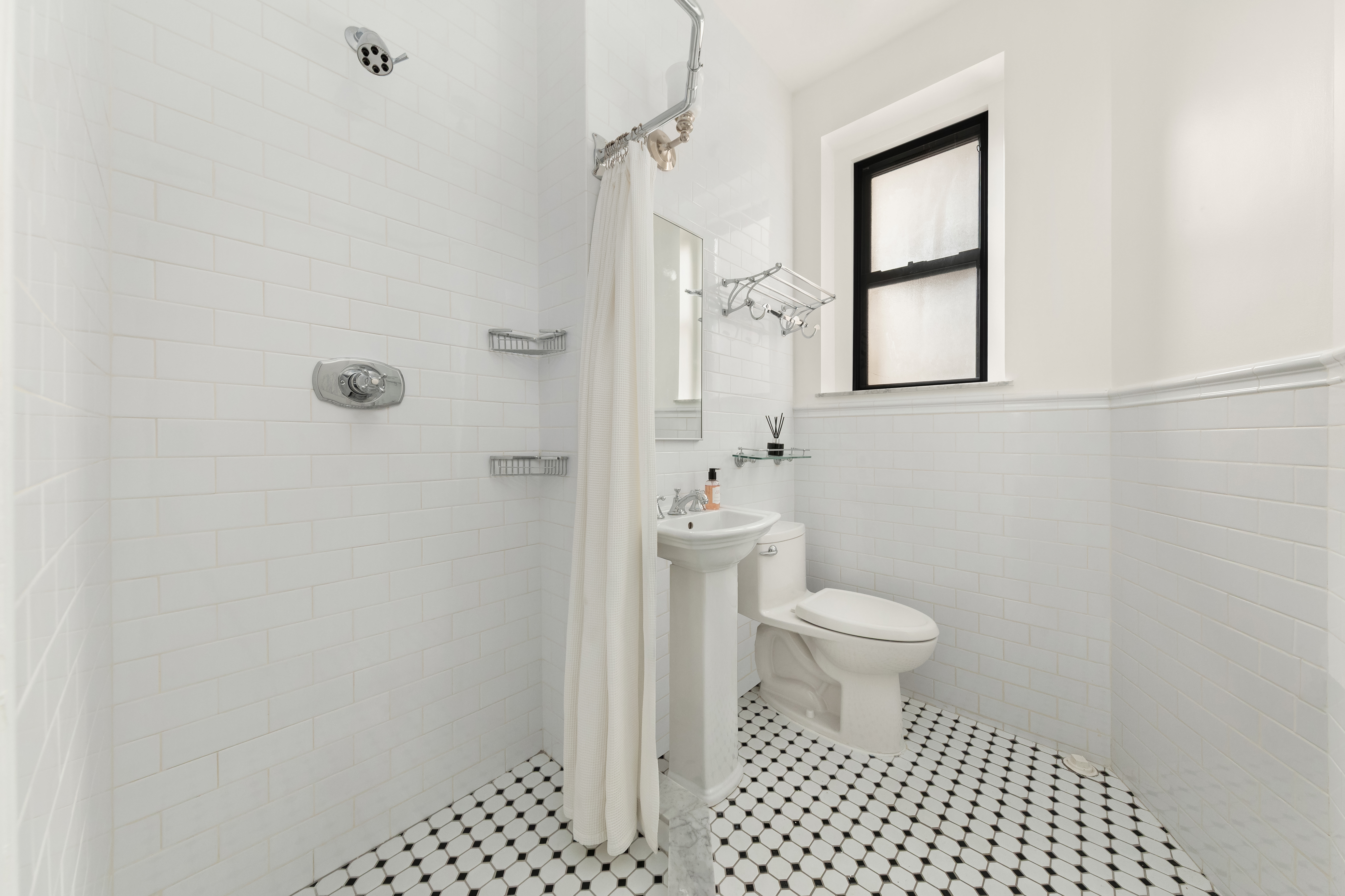 929 Park Avenue, Unit 6C Manhattan, NY 10028 - Photo 6 of 10 a bathroom with a toilet and a shower