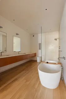 a bathroom with a tub and a sink