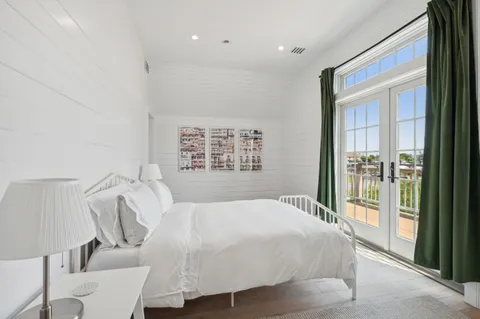 a bathroom with double vanity and a glass door shower