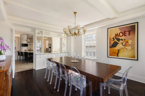a view of a a dining room with furniture window and wooden floor