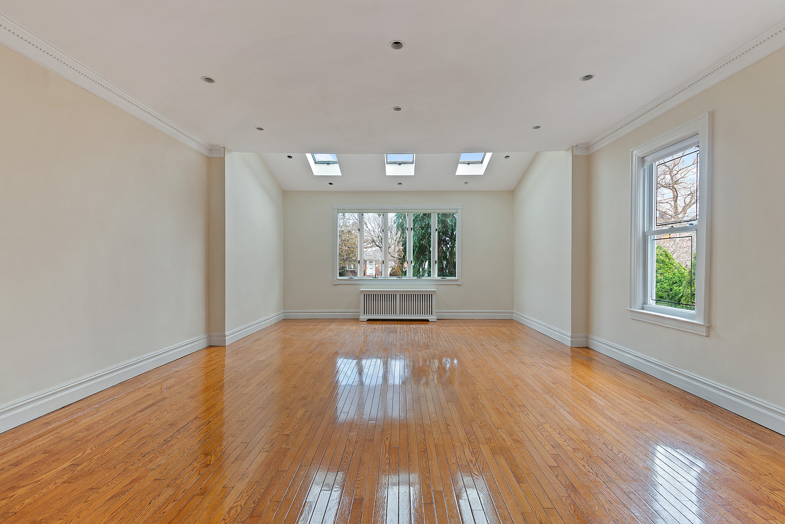 96 86th Street Brooklyn, NY 11209 - Photo 2 of 13 a view of an empty room with wooden floor and a window