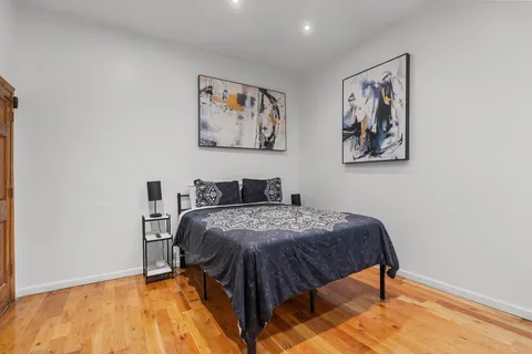 a bed sitting in a bedroom next to a blue wall
