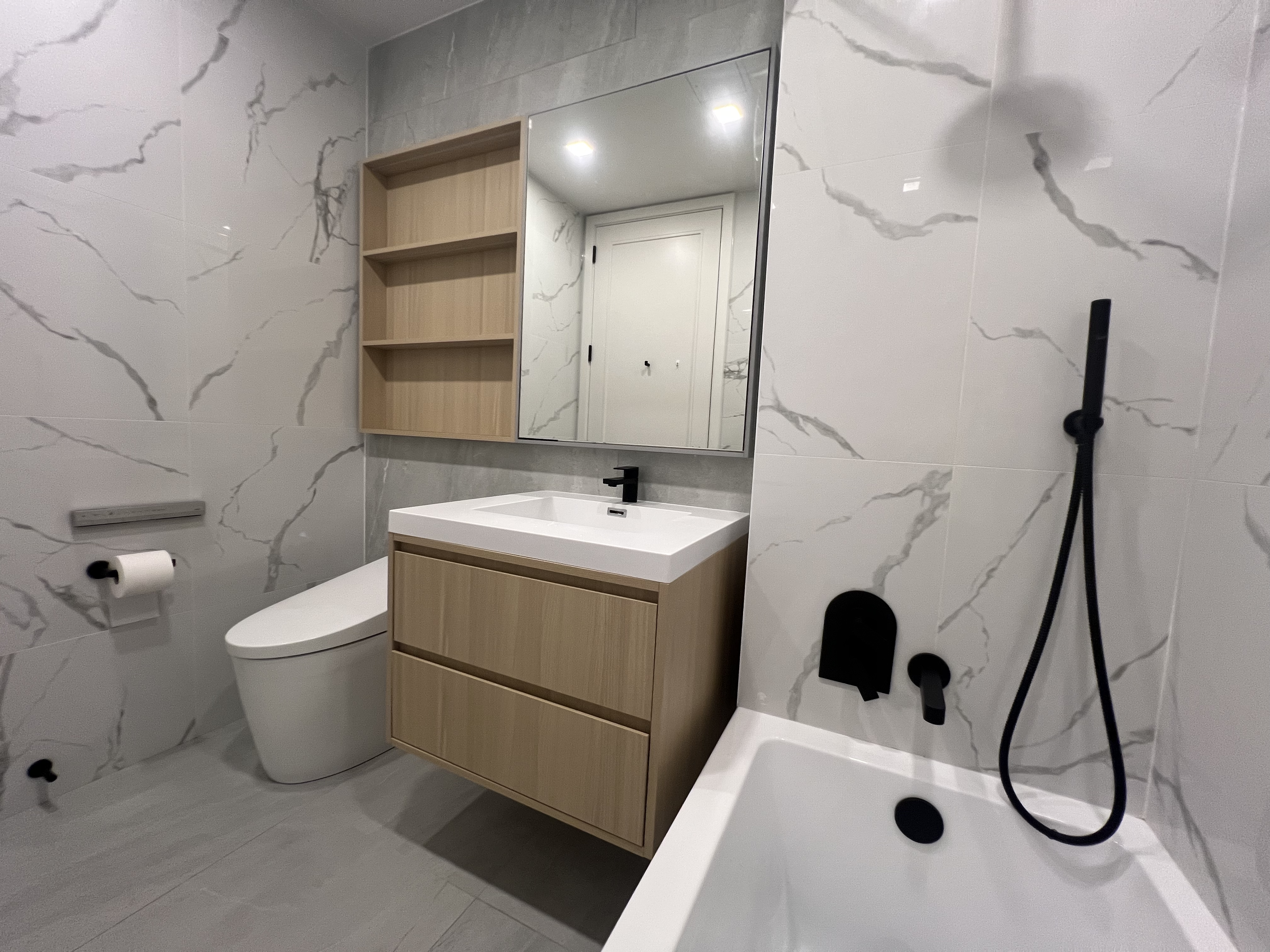 37-34 33rd Street, Unit 7H Queens, NY 11101 - Photo 10 of 18 a bathroom with a sink toilet and shower