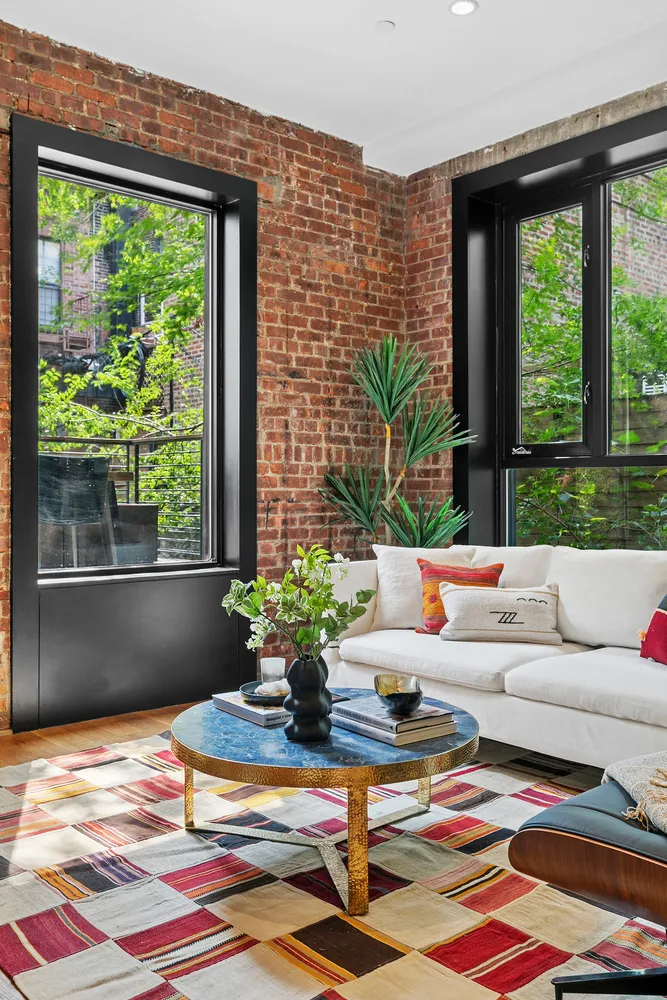 a living room with patio furniture and a potted plant