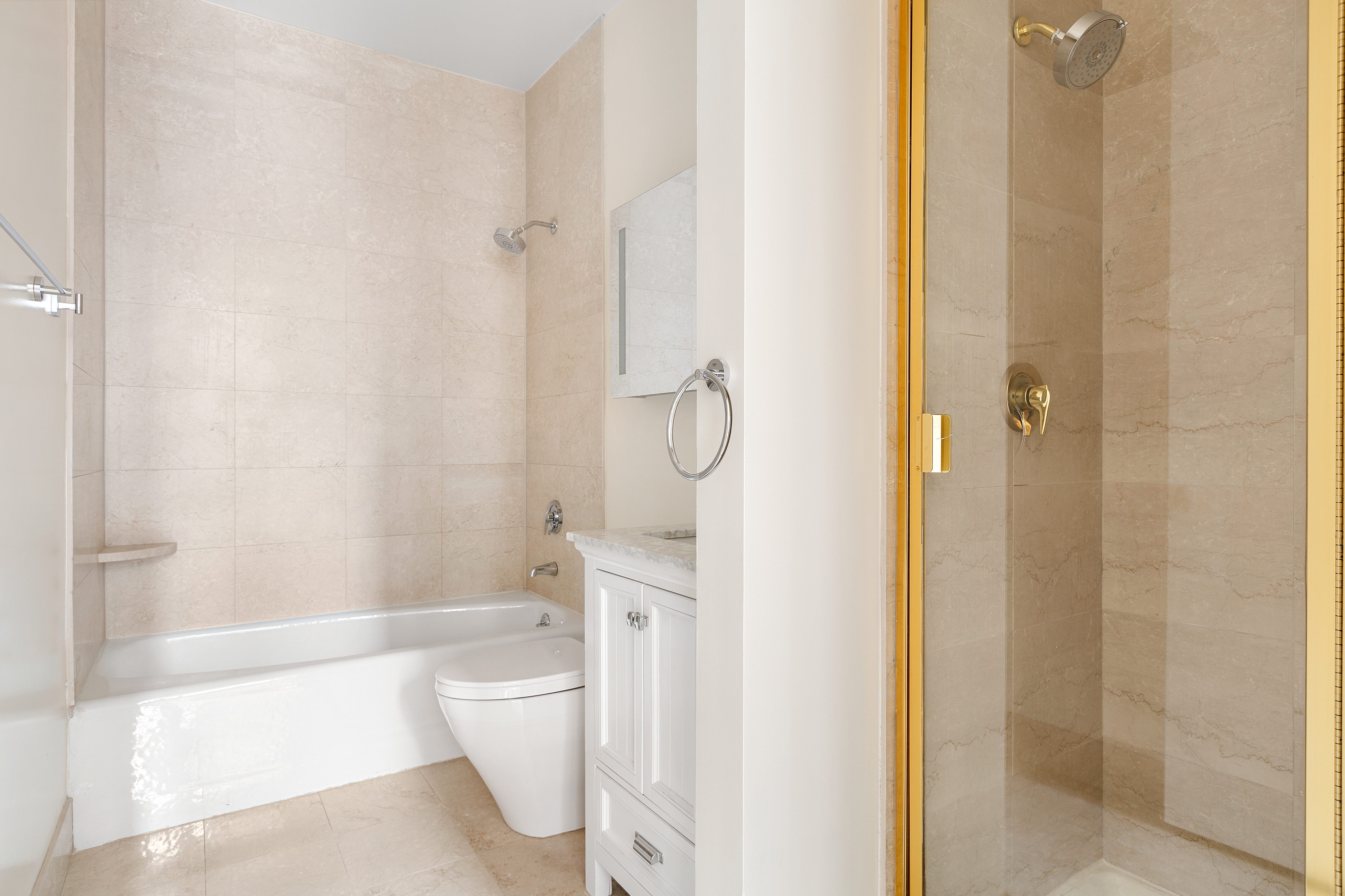 120 East 87th Street, Unit R10C Manhattan, NY 10128 - Photo 5 of 13 a bathroom with a granite countertop bathtub shower and toilet