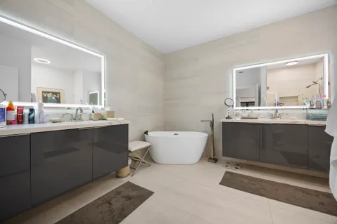 a bathroom with a granite countertop sink a toilet and a mirror