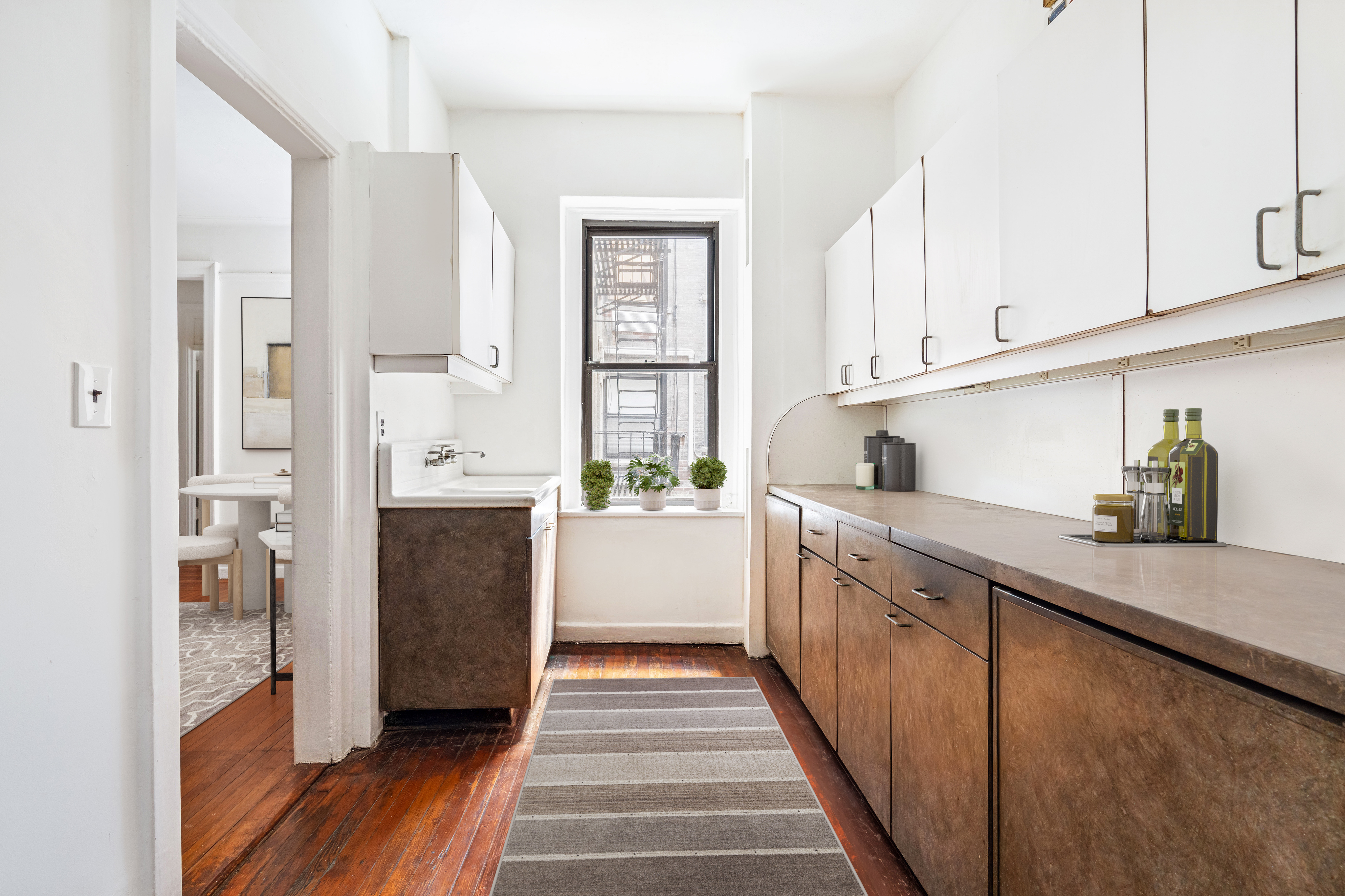 130 West 16th Street, Unit 3 Manhattan, NY 10011 - Photo 4 of 8 a kitchen with stainless steel appliances kitchen island granite countertop a refrigerator and a sink