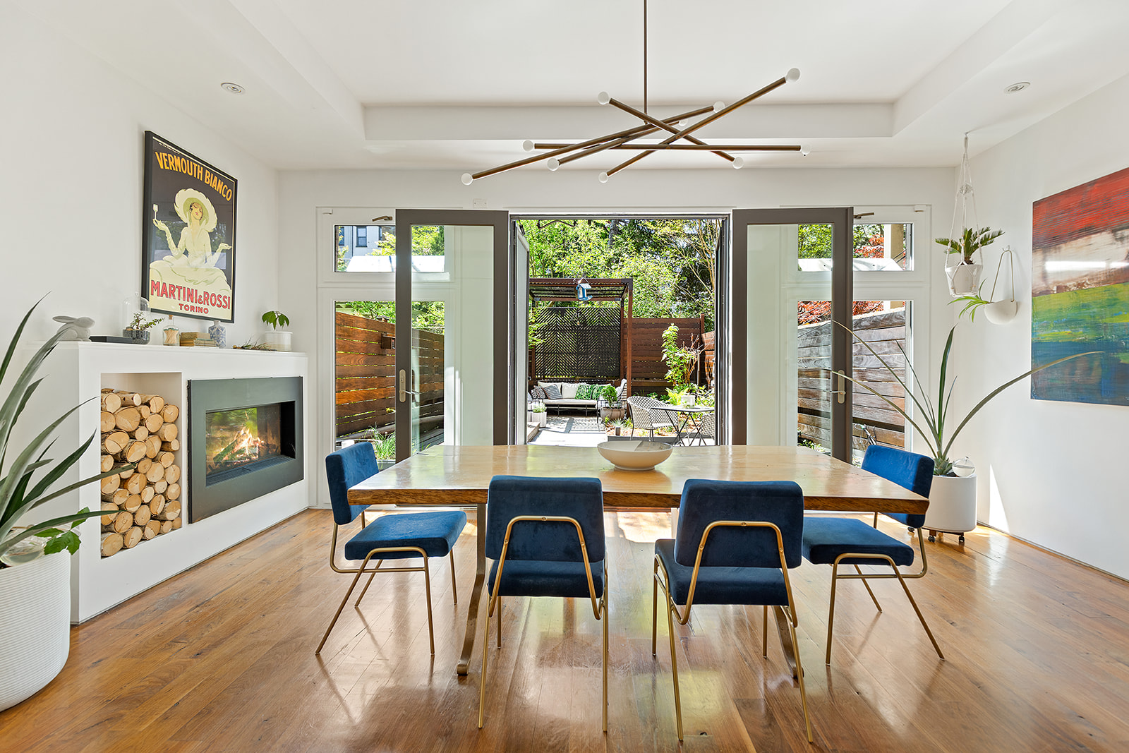 a dining room with furniture a chandelier and wooden floor