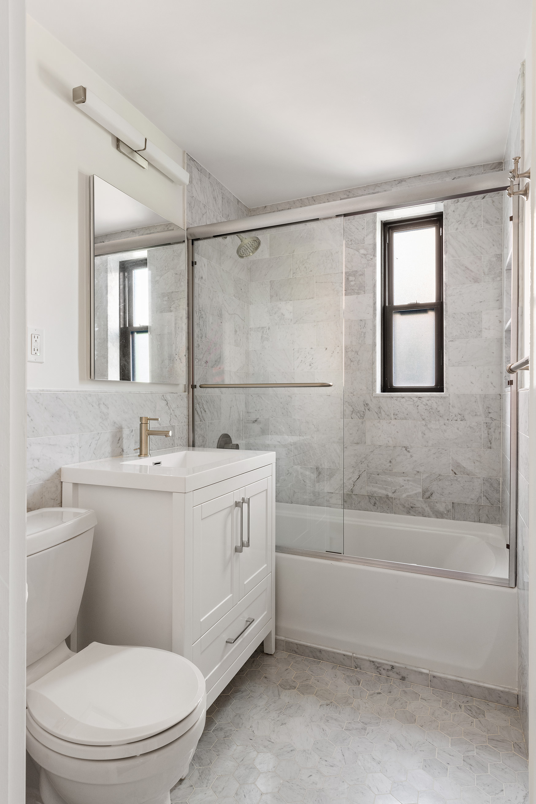81 Bedford Street, Unit 4B Manhattan, NY 10014 - Photo 11 of 15 a bathroom with a sink a toilet and shower
