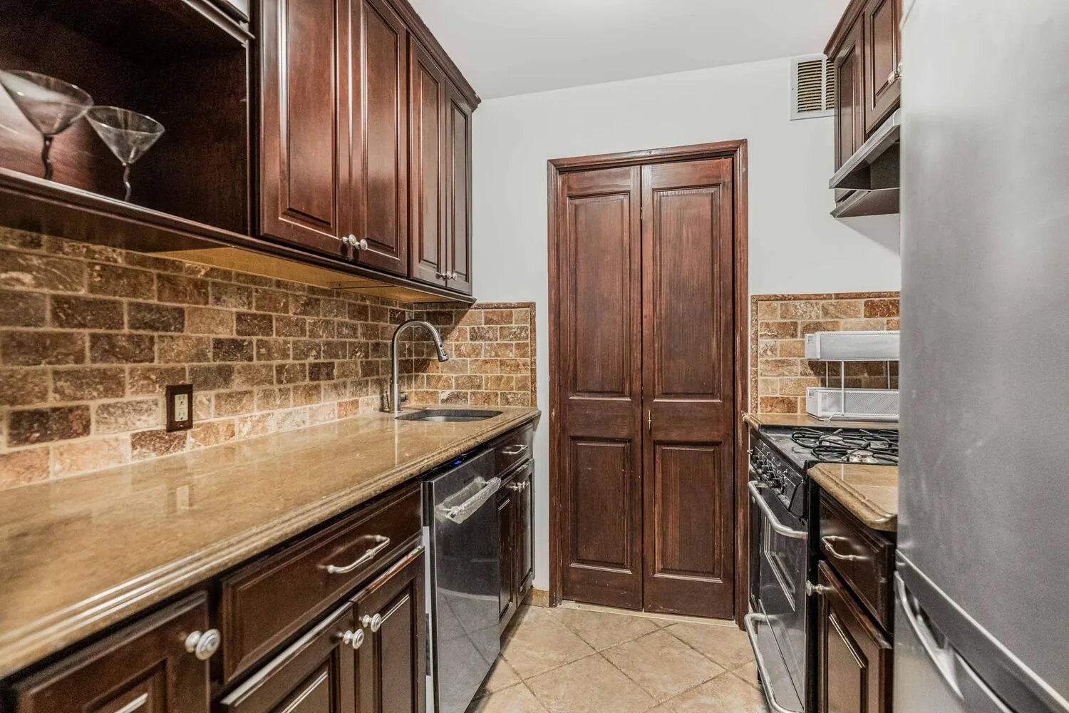 a kitchen with a sink and cabinets
